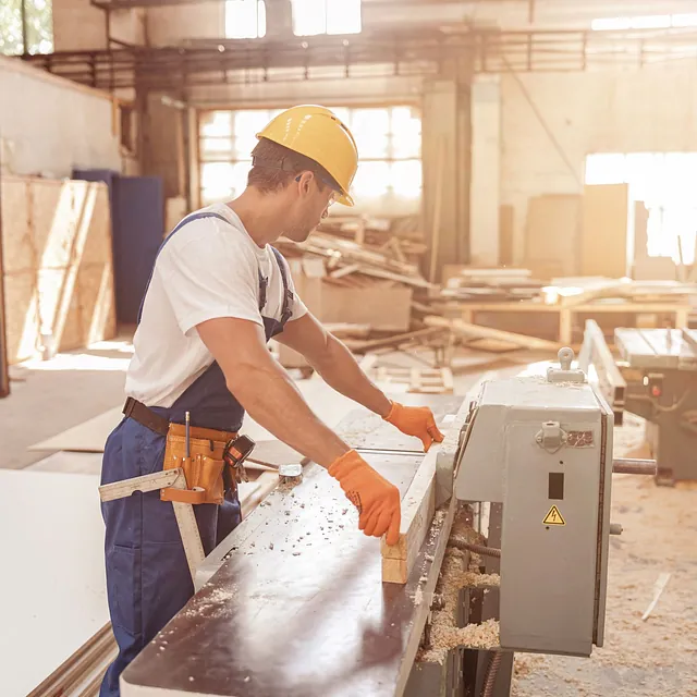 male-worker-using-woodworking-machine-carpentry-workshop