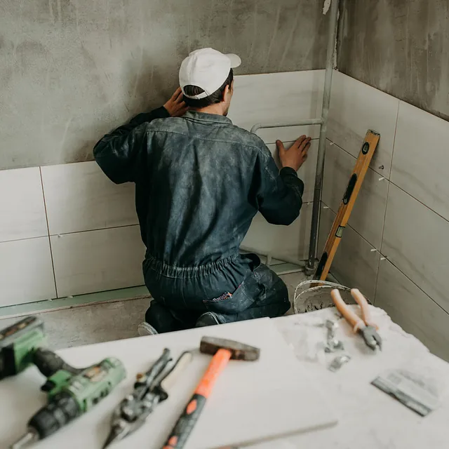 worker-repairman-puts-large-ceramic-tiles